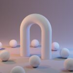 a group of white balls sitting next to a white arch